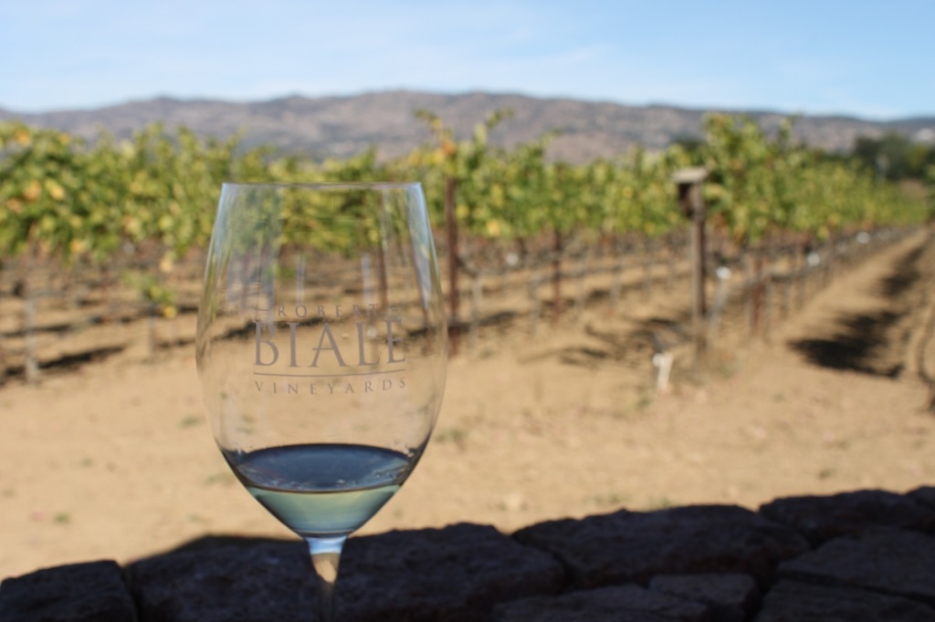 Biale glass in foreground; vines and mountains in background