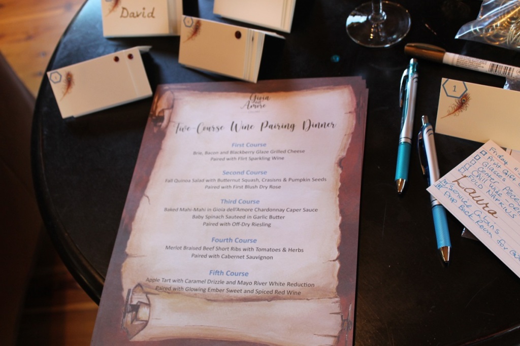 copy of dinner menu, with name plates nearby