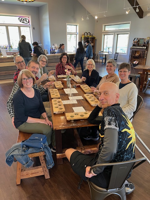 group sitting around table with flights of mead in front of each person
