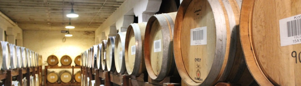 wooden barrels stacked in rows at Korbel