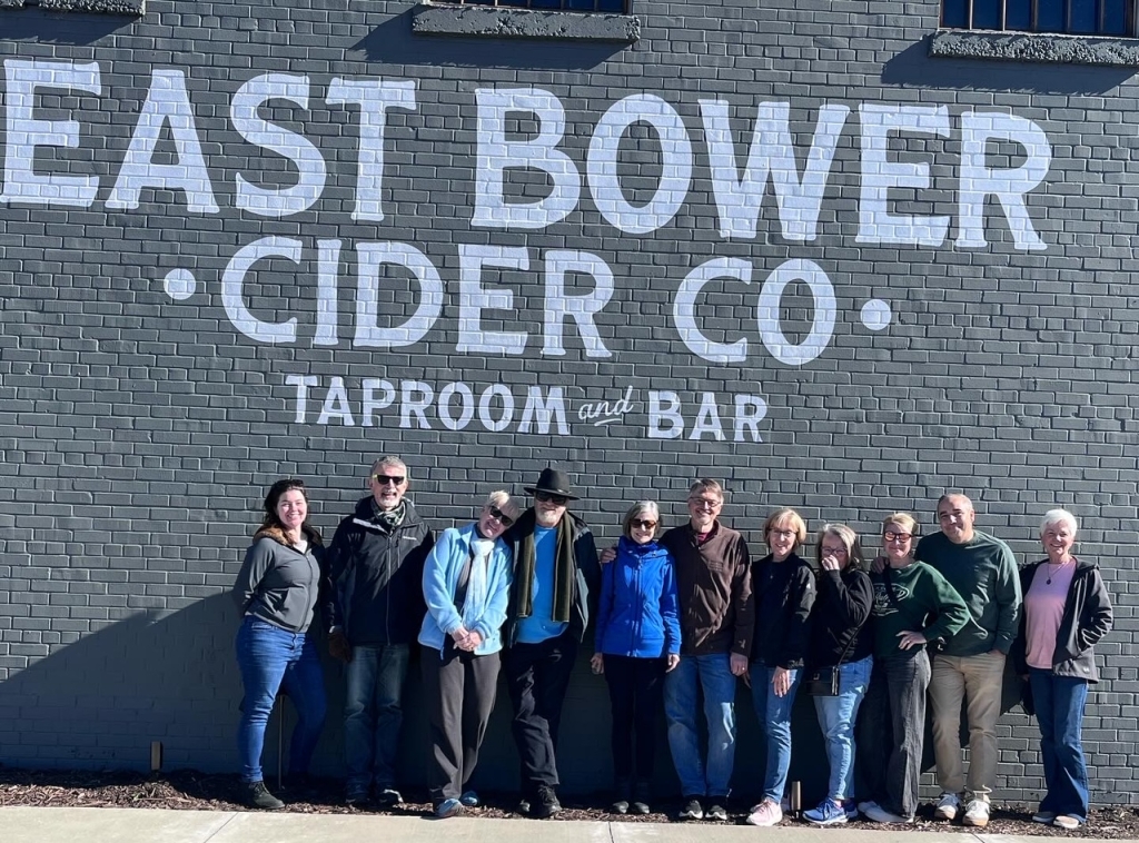 group lined up by East Bower Cider sign
